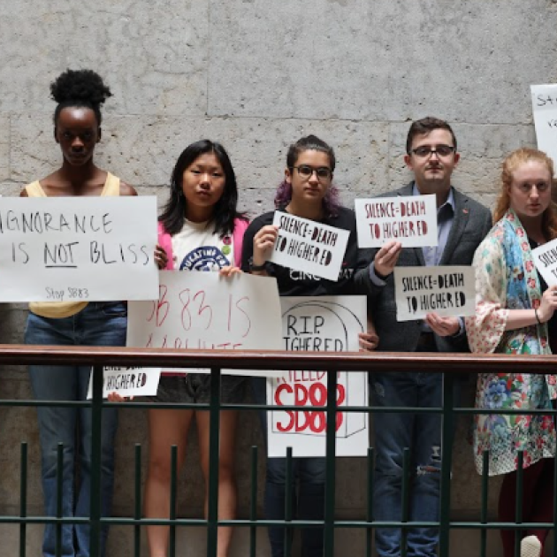 Students holding signs