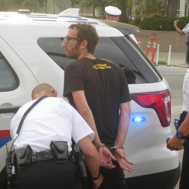 Activist being handcuffed by police