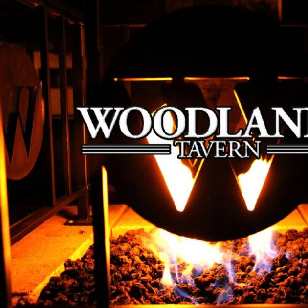 Fire in stove behind words Woodlands Tavern