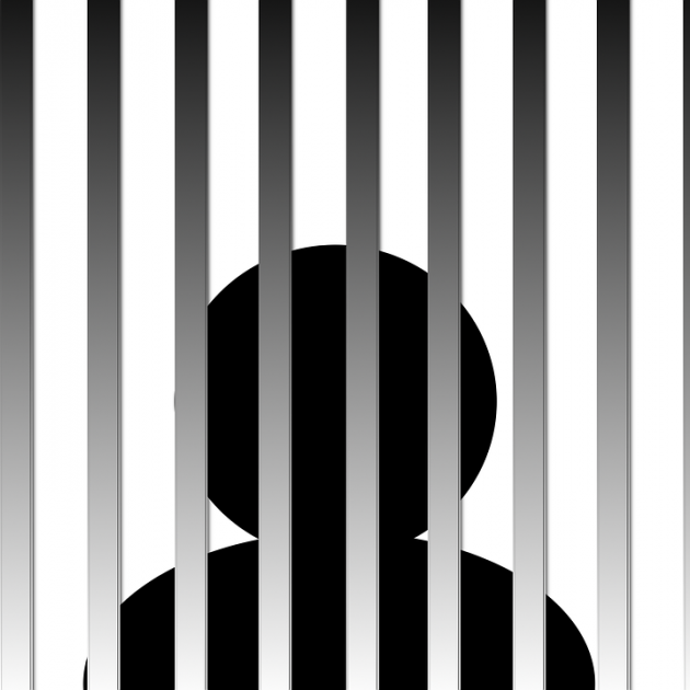 A black figure behind gray bars like a jail cell