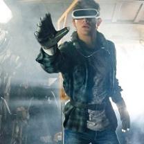 Man with big screen-like goggles like virtual reality headgear with a big glove stretched out on his hand 