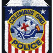 Badge with Santa Maria in center and red/white/blue background saying Columbus Ohio Police