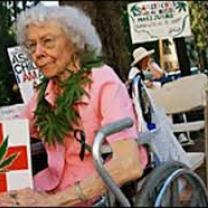 Elderly woman with marijuana sign