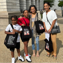 A mother and three kids posing