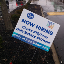 Yard sign saying Kroger is hiring people at $10 and $11 dollars an hour
