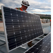 Men installing solar panels on a roof