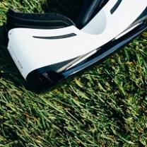 White and black virtual reality goggles laying on grass