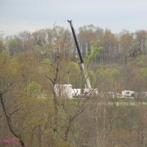 What looks like a crane and extracting equipment within trees in a forest
