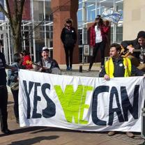 People holding Yes We Can sign