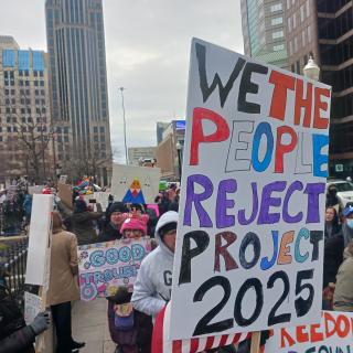 Sign saying We the People reject Project 2025