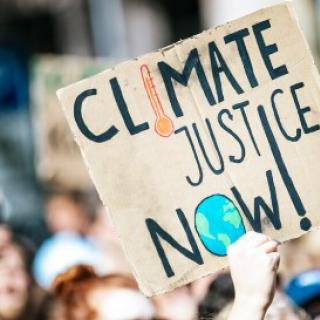 Sign saying climate justice now