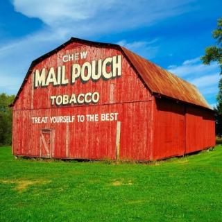 Red barn with Mailpouch written on it