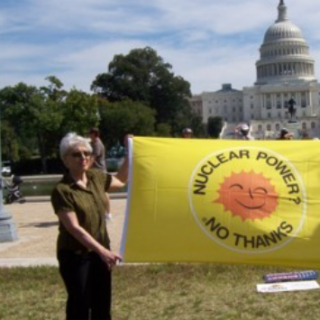 People holding sign saying Nuclear Power No Thanks in front of Congress 