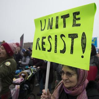 Sign at protest saying Unite Resist