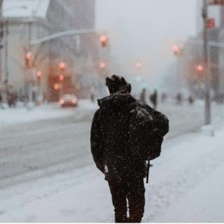 Back of man outside on a snowy street