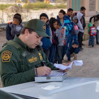 Border patrol and line of immigrants