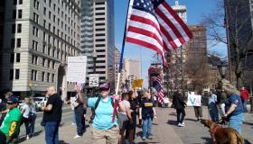 Protesters and one holding US flag