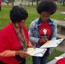 Two black women discussing registering to vote