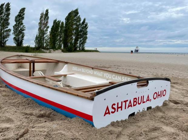 Boat on sandy beach with Ashtabula Ohio on it