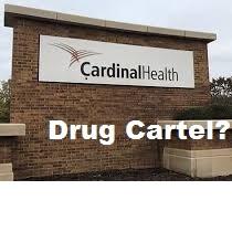Brick sign outside with words Cardinal Health and words superimposed over picture in white below saying Drug Cartel?