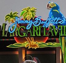Neon sign with a parrot, palm trees, and the words in script Jimmy Buffet and the word in large capitals Margaritaville