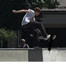 Boy doing a jump n a skateboard over a railing