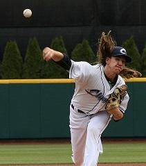 Pitcher throwing a pitch with long hair flying