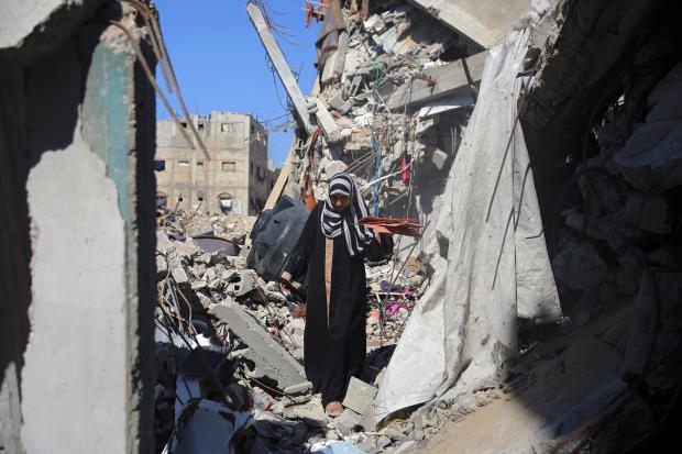 Woman standing amid rubble