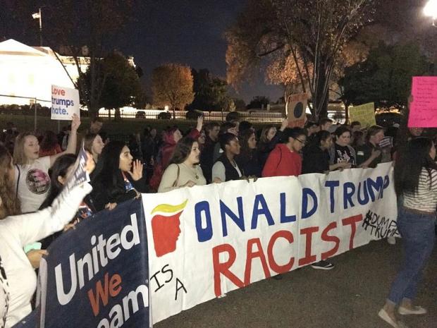 Anti-Trump protest with Trump is racist sign