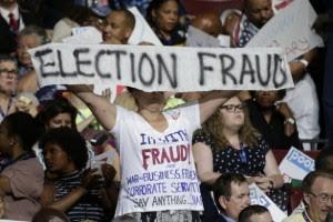 Bernie delegates holding up Election Fraud sign at DNC
