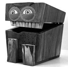 Big box with lid open and two eyes and teeth like a face