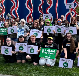 CMA workers with signs posing outside