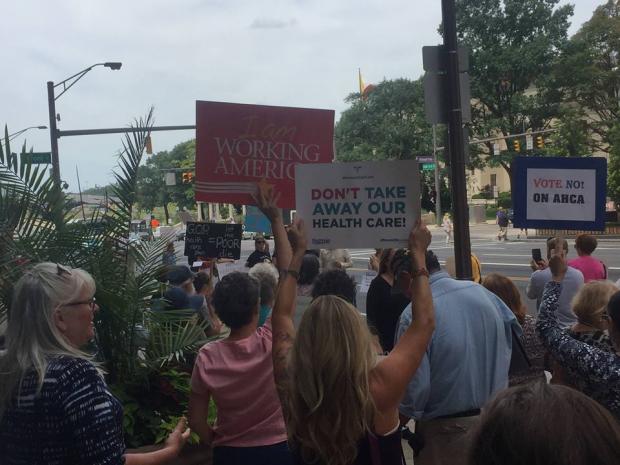 People holding signs about health care