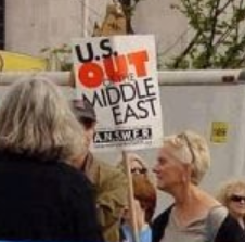 Woman holding a sign saying US Out of the Middle East