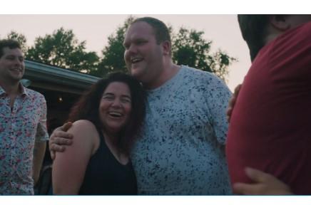 Man hugging woman while both laughing