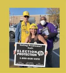 People posing with Election Protection sign