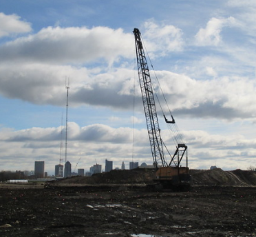 Crane over property with skyline in background