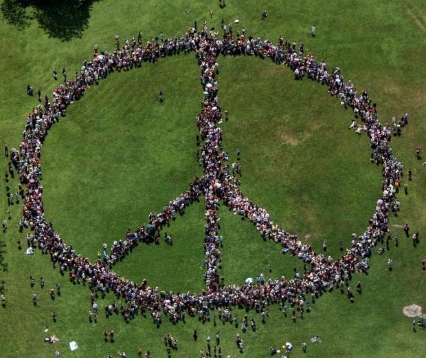 People standing as a peace sign from a distance
