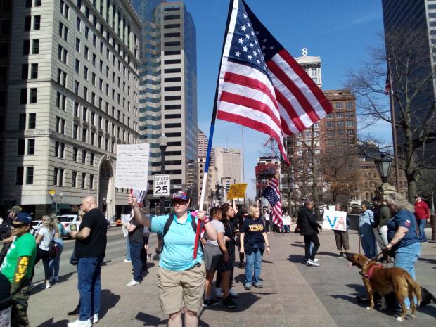 Protesters and one holding US flag