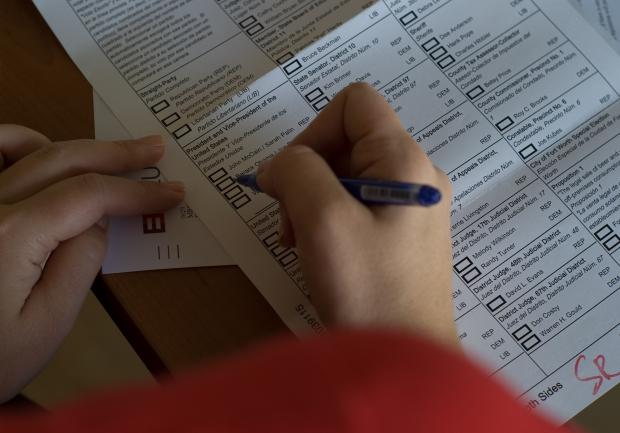 Person voting on paper