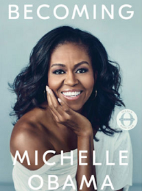 Pretty black woman smiling with long black hair waving in the wind wearing a white shirt that is off one shoulder and words Becoming at top and MIchelle Obama below
