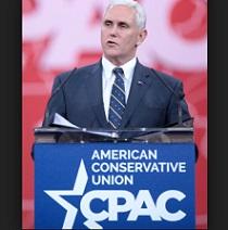 White haired older man in a blue suit and tie behind a podium that says American Conservative Union