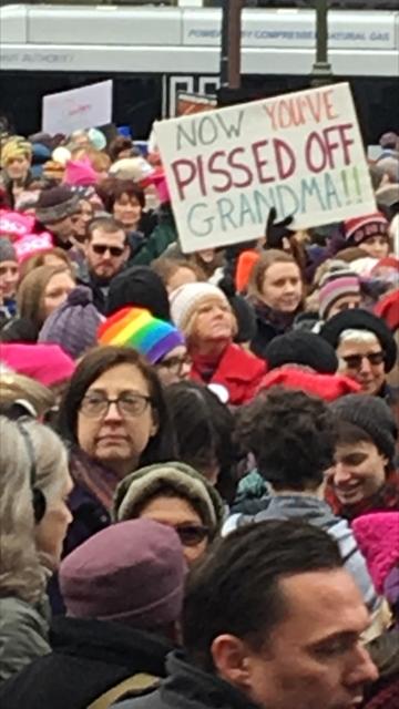 A crowd of mostly women and a sign reading Pissed Off Grandma!