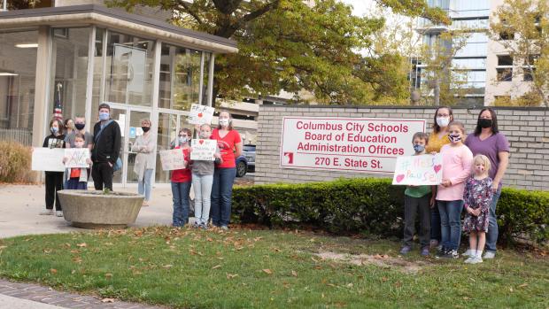People posing in protest outside Cols City Schools