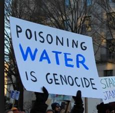 Sign saying Poisoning water is genocide