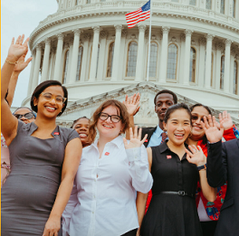 People posing in front of the US Capitol