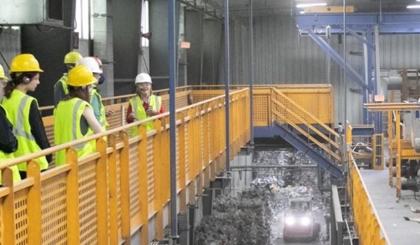 People in hard hats walking through facility