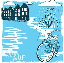 Light blue colored background black and white cartoony houses at top left and clouds and the words the Salty Caramels over a bike and white puddles and the words in white Baby Blue