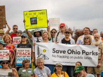 Outdoor protest with signs about Save Ohio Parks