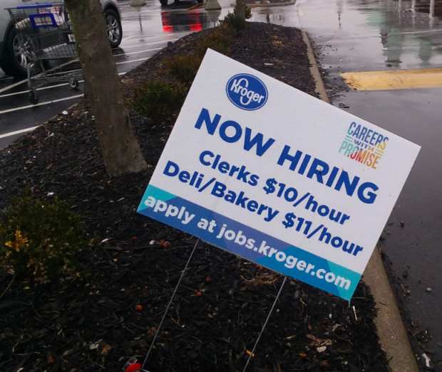 Yard sign saying Kroger is hiring people at $10 and $11 dollars an hour